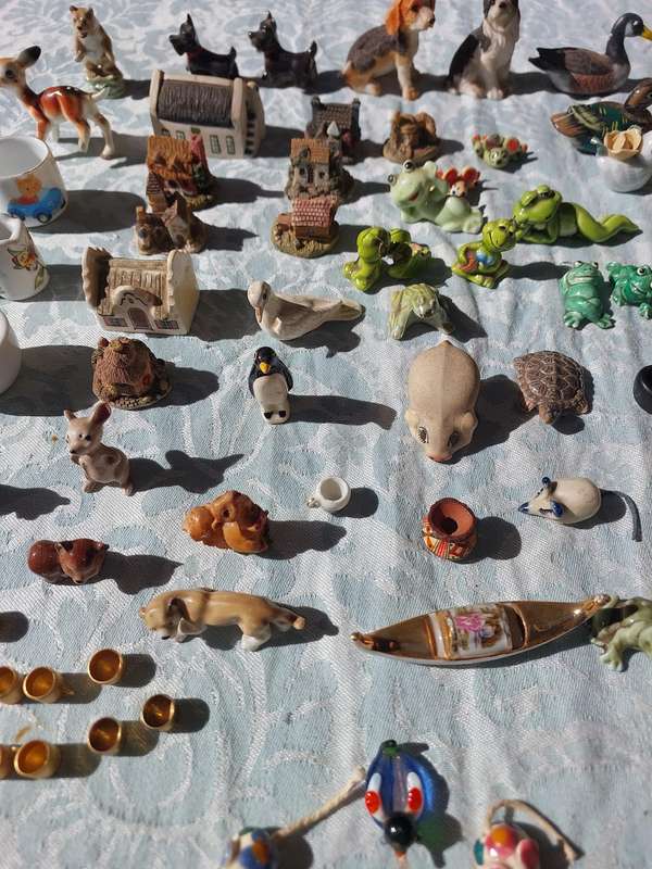 AN ENTIRE COLLECTION PORCELAIN CHARMS AND FIGURINES SOLD AS IS
