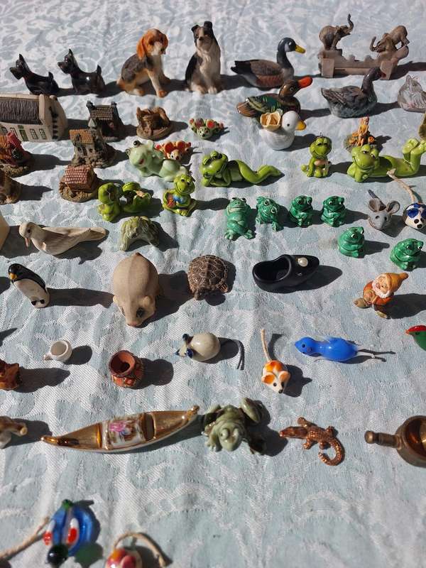 AN ENTIRE COLLECTION PORCELAIN CHARMS AND FIGURINES SOLD AS IS