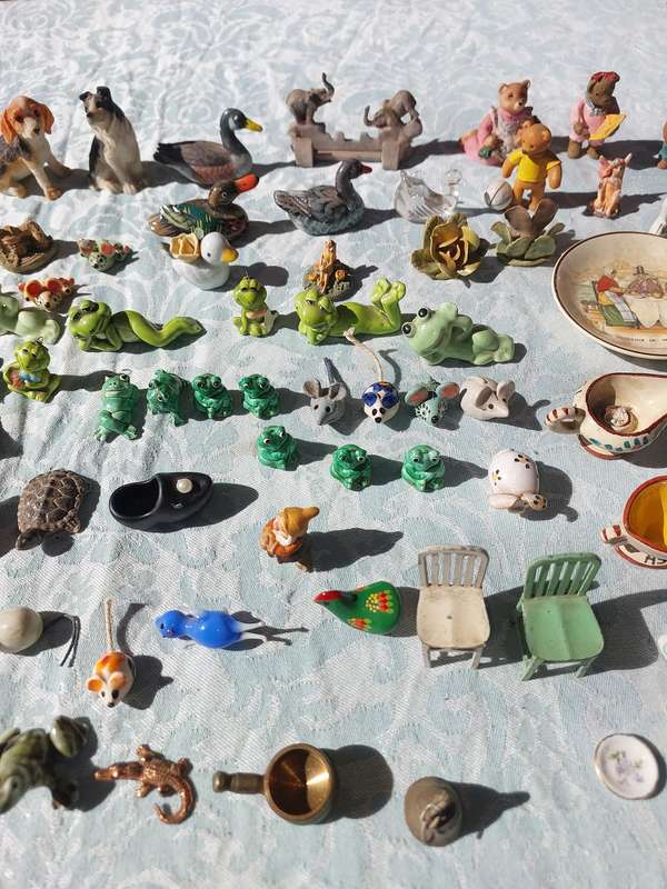 AN ENTIRE COLLECTION PORCELAIN CHARMS AND FIGURINES SOLD AS IS
