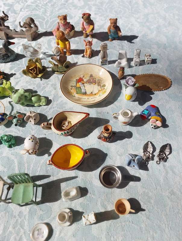 AN ENTIRE COLLECTION PORCELAIN CHARMS AND FIGURINES SOLD AS IS