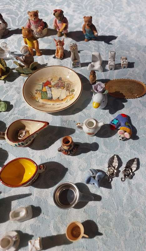 AN ENTIRE COLLECTION PORCELAIN CHARMS AND FIGURINES SOLD AS IS