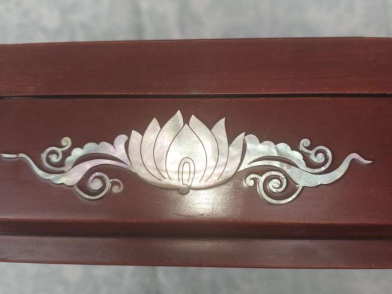 A LACQUER WOODEN JEWELRY BOX WITH WOODEN INSERTS AND A MOTHER PEARL INLAY OF PEACOCKS AND FLORAL IN
