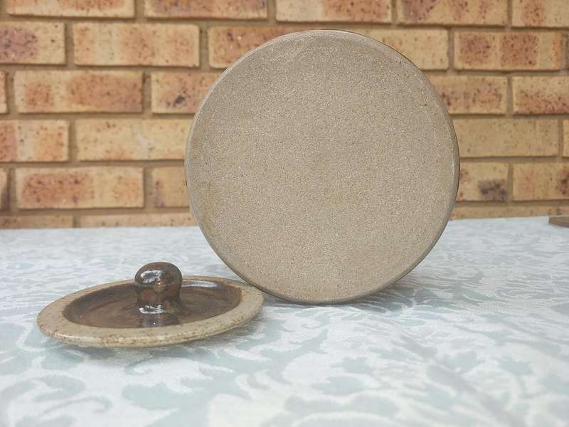 A BAKED CLAY CERAMIC TEAPOT WITH A BAMBOO HANDLE SOLD AS IS
