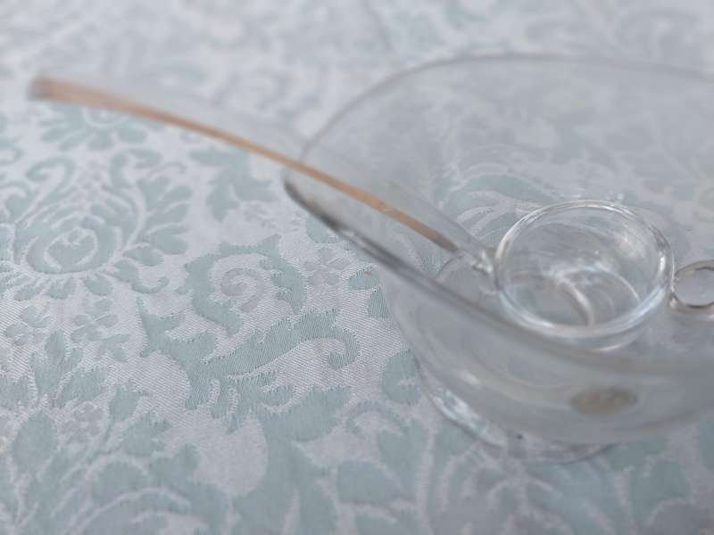A CUT GLASS SAUCE JUG AND LADLE MADE IN ROMANIA SOLD AS IS