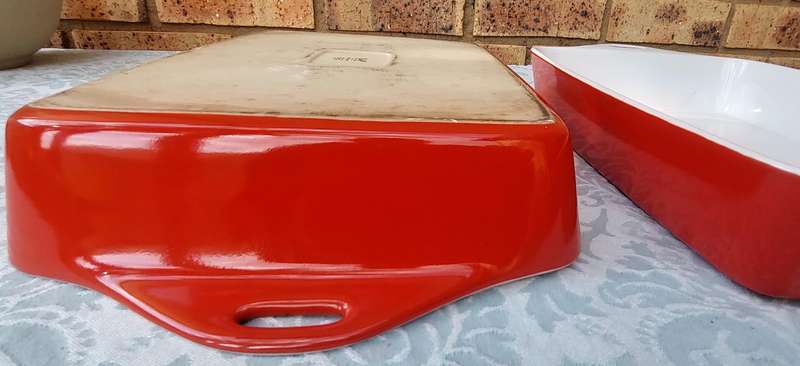 A PAIR OF RED AND WHITE CASSEROLE DISHES IN GOOD CONDITION SOLD AS IS