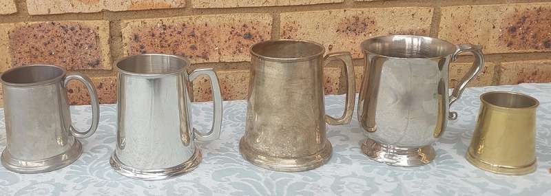 A COLLECTION OF BEER MUGS SOLD AS IS