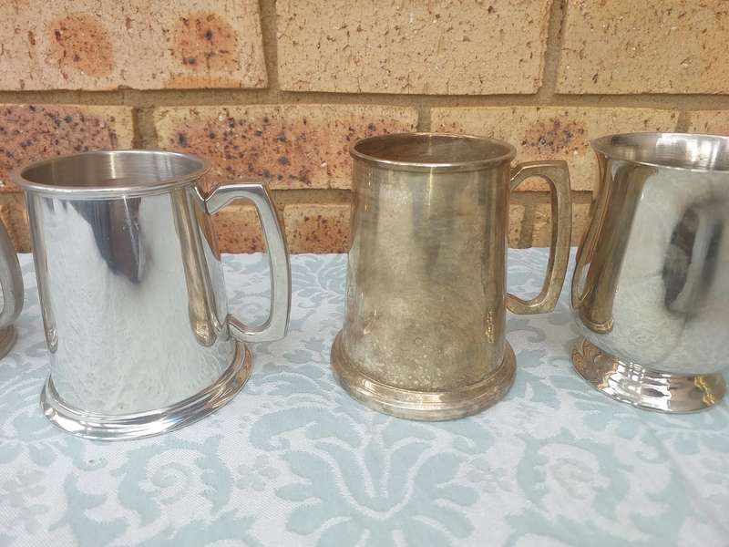 A COLLECTION OF BEER MUGS SOLD AS IS