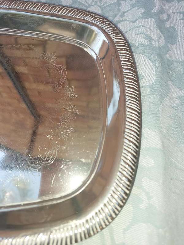 A STAINLESS STEEL SERVING TRAY SOLD AS IS
