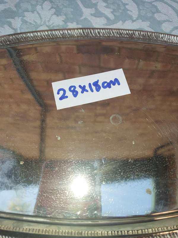 A STAINLESS STEEL SERVING TRAY SOLD AS IS