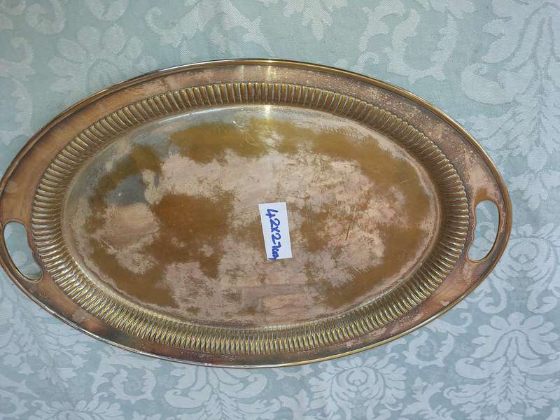 AN OVAL VICTORIAN SILVERPLATED ON BRASS TRAY SOLD AS IS