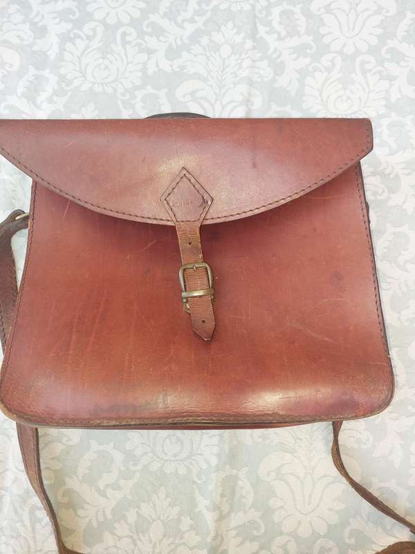 A BROWN LEATHER BRIEF CASE SOLD AS IS