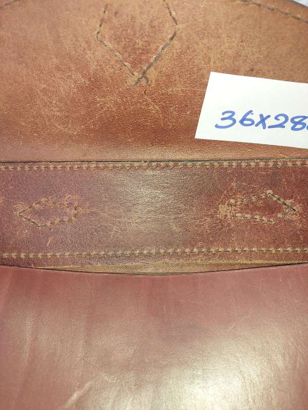 A BROWN LEATHER BRIEF CASE SOLD AS IS