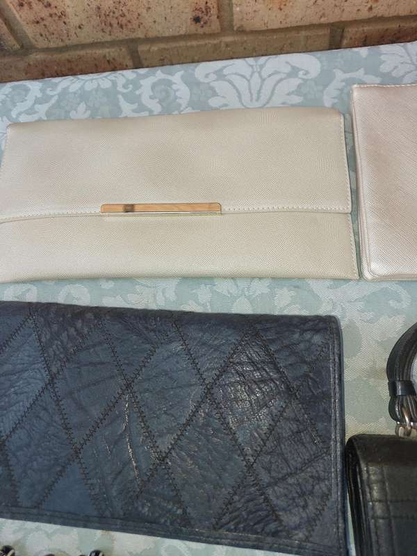A COLLECTION OF CLUTCH BAGS SOLD AS IS