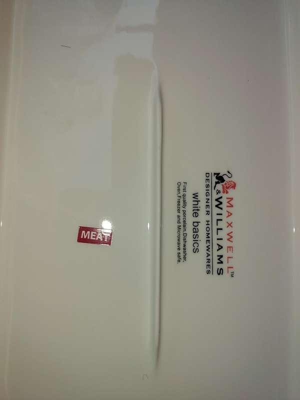 A COLLECTION OF WHITE PORCELAIN PLATTERS SOLD AS IS