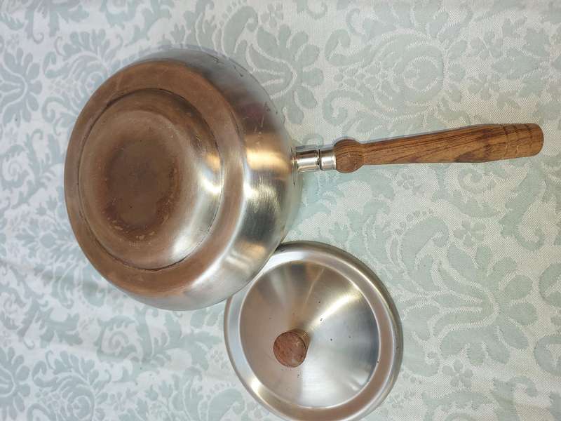 A VINTAGE SAUCE PAN WITH WOODEN HANDLE AND WARMER STAND