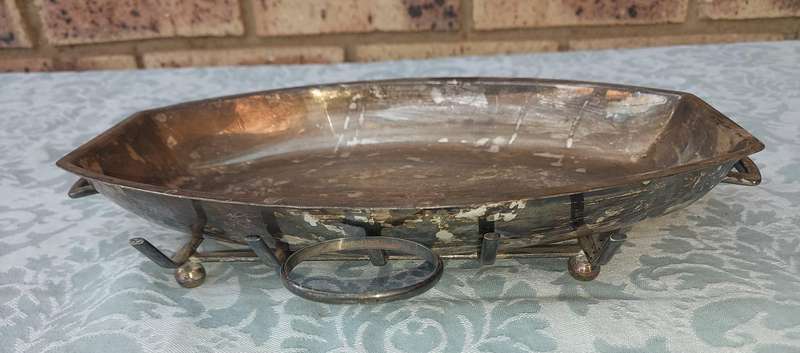 A VINTAGE SILVER PLATED SERVING PLATTER ON A SERVING STAND SOLD AS IS