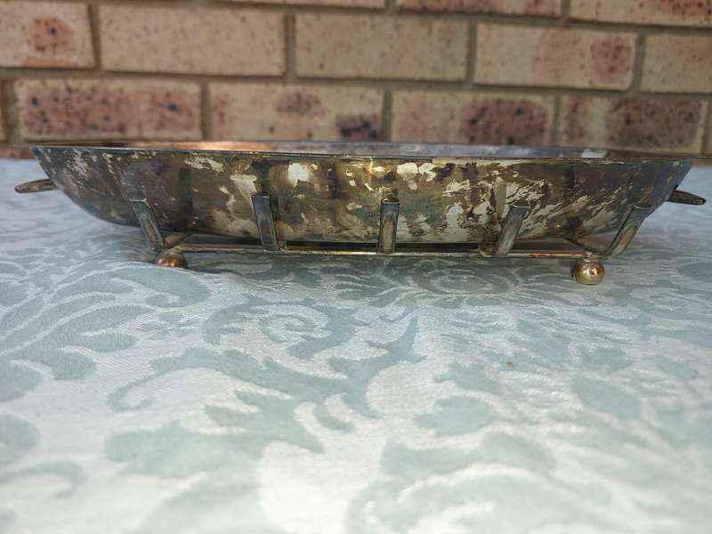 A VINTAGE SILVER PLATED SERVING PLATTER ON A SERVING STAND SOLD AS IS