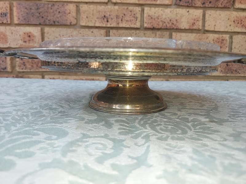 A VINTAGE LAZY SUZAN WITH A SILVER PLATED TRAY , THE HANDLE NEEDS REPAIRS SOLD AS IS