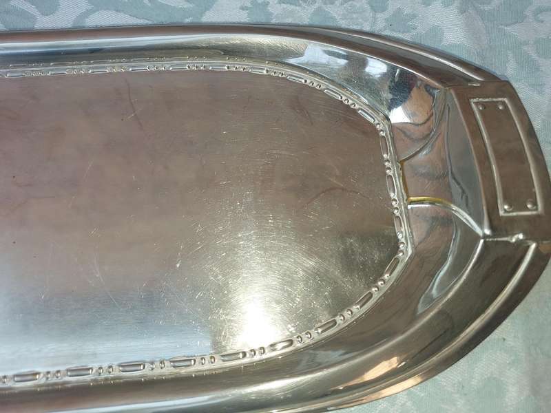 A SILVER PLATED RECTANGULAR SERVING PLATER SOLD AS IS