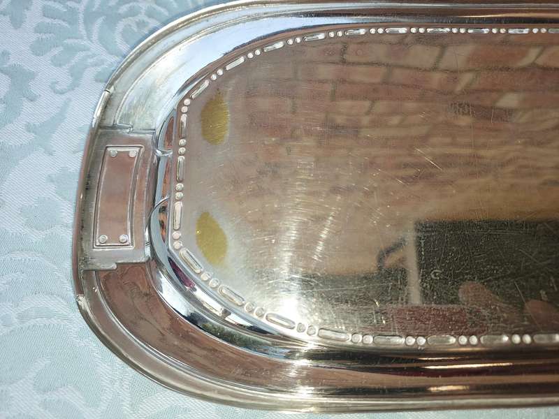 A SILVER PLATED RECTANGULAR SERVING PLATER SOLD AS IS
