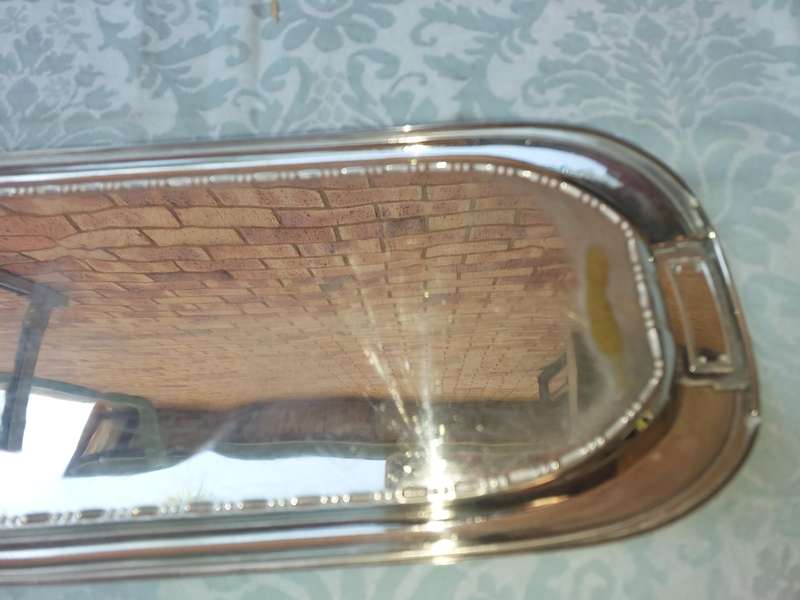 A SILVER PLATED RECTANGULAR SERVING PLATER SOLD AS IS