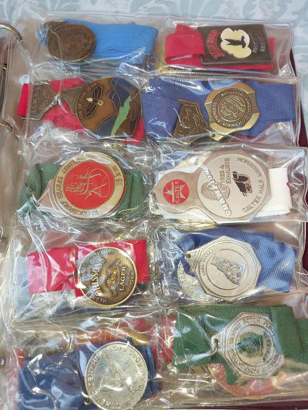 AN ENTIRE ATHLETES ALBUM WITH ALL THE MEDALS SOLD AS IS