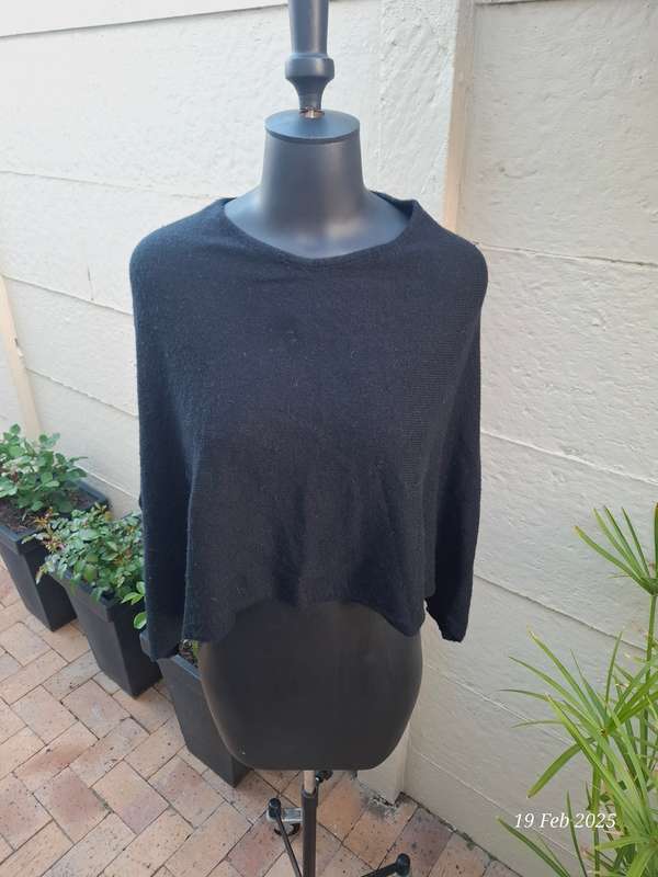 Black knit asymmetrical hemline knit poncho by Divided H&M. One size