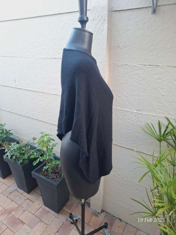 Black knit asymmetrical hemline knit poncho by Divided H&M. One size