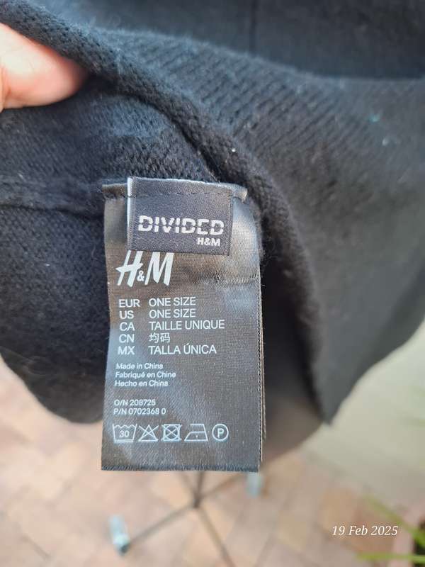 Black knit asymmetrical hemline knit poncho by Divided H&M. One size