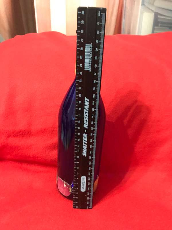 Cobalt bottle with printed apples and has a top