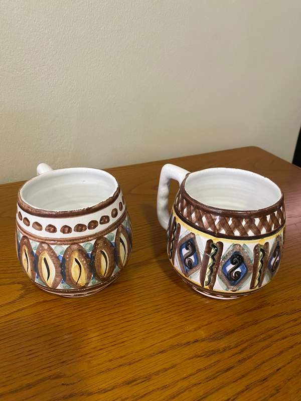 Two South African ceramic beer mugs