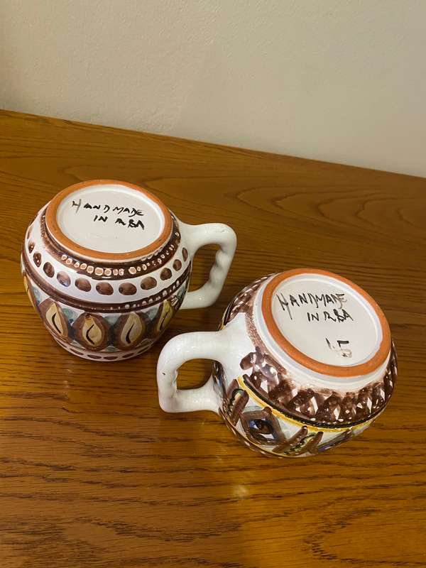 Two South African ceramic beer mugs