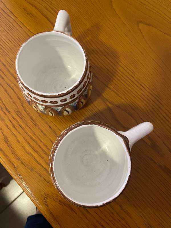 Two South African ceramic beer mugs