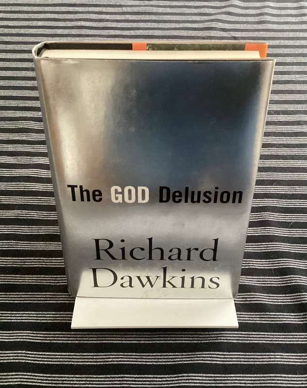 THE GOD DELUSION by Richard Dawkins. Hardback, silver cover edition, in an excellent condition.
