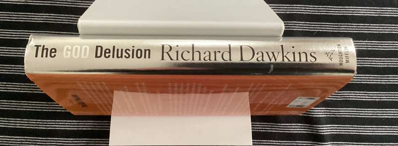 THE GOD DELUSION by Richard Dawkins. Hardback, silver cover edition, in an excellent condition.