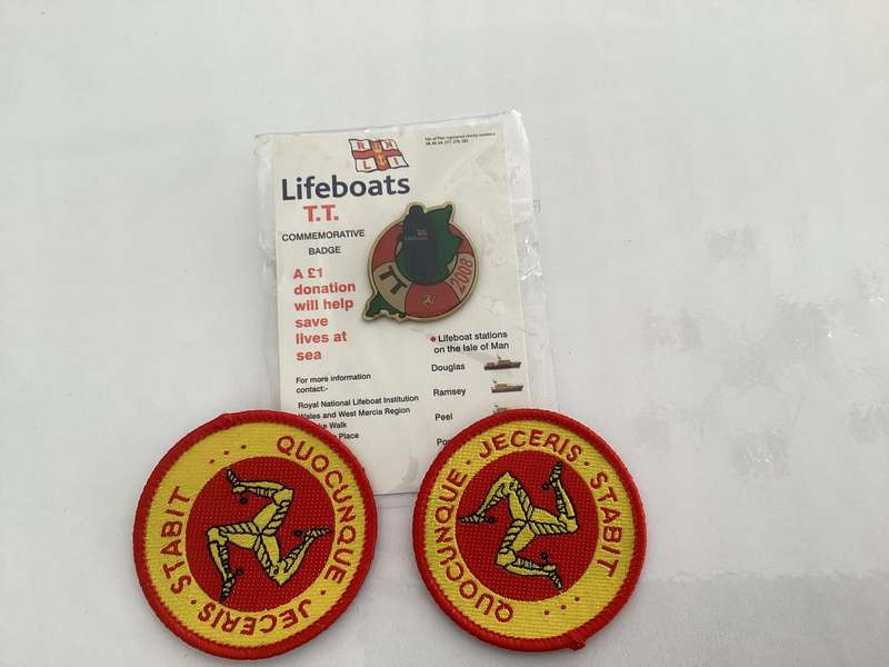 Manx Cat pins (x3), two sew-on badges and one TT/Lifeboat commemorative lapel badge