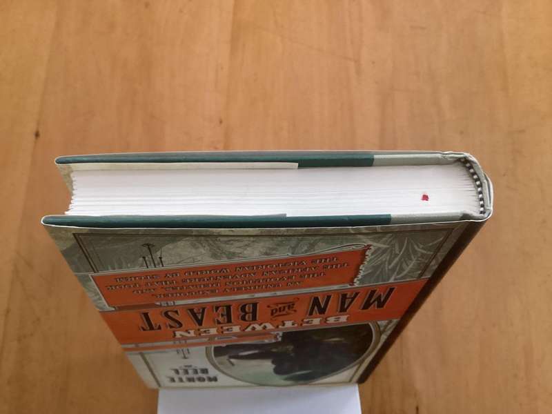 BETWEEN MAN and BEAST. True Story, by Monte Reel. Hardcover in a VG+ condition.