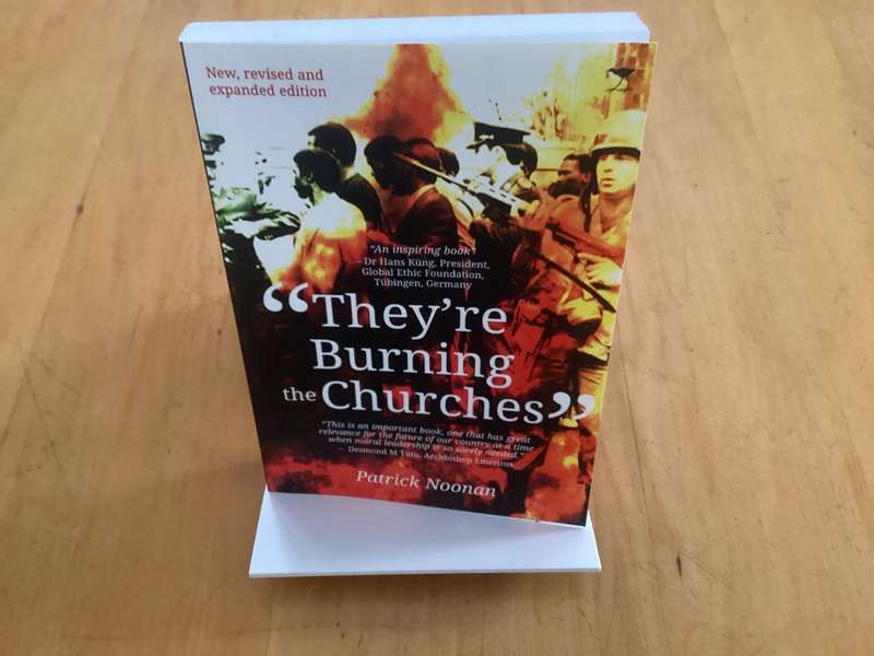 THEYRE BURNING THE CHURCHES, by Patrick Noonan, paperback excellent condition.