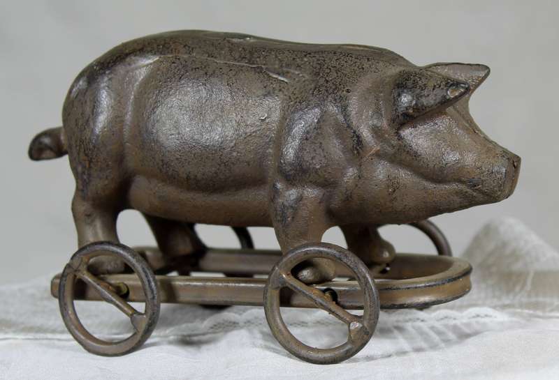 Vintage cast metal pig on wheels