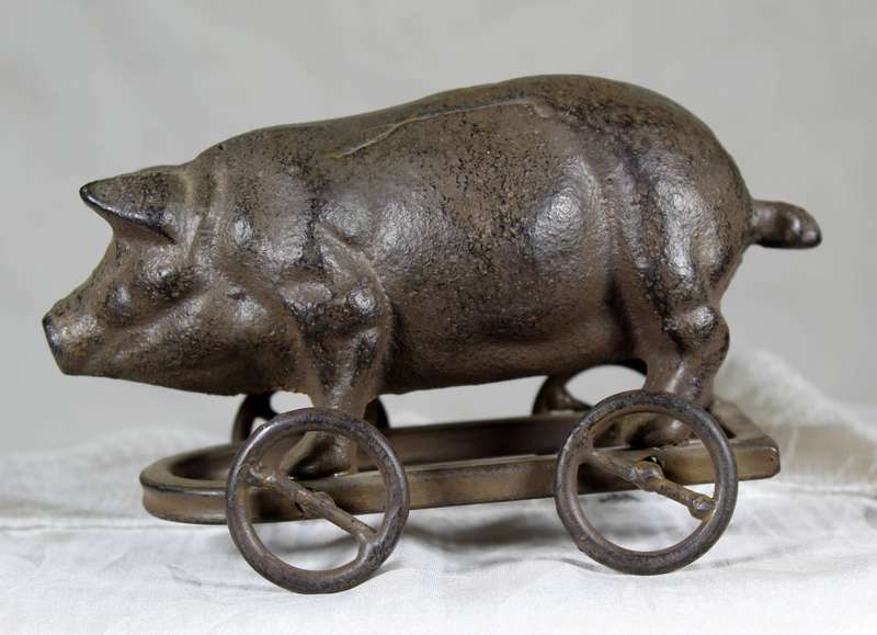 Vintage cast metal pig on wheels