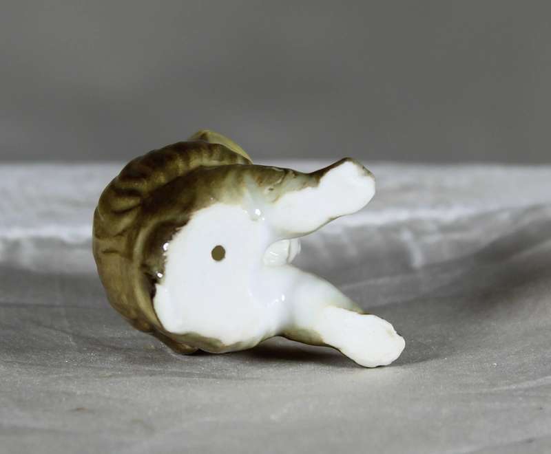 Miniature porcelain seated baboon
