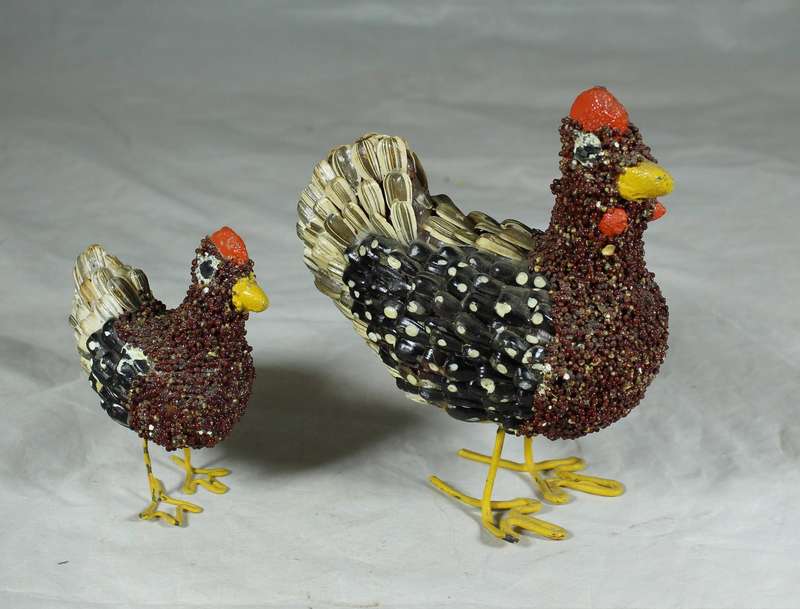 Pair of chickens covered with seeds