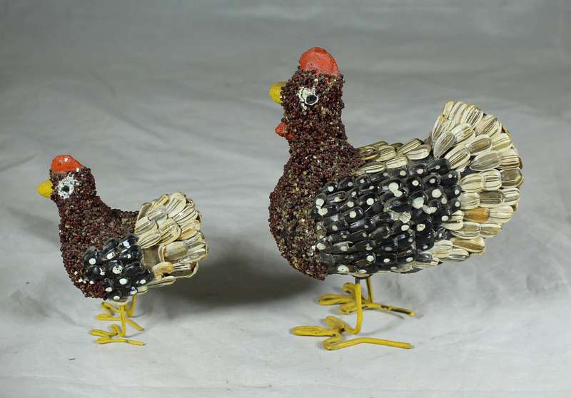 Pair of chickens covered with seeds