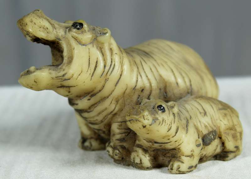 Miniature mommy and baby hippos
