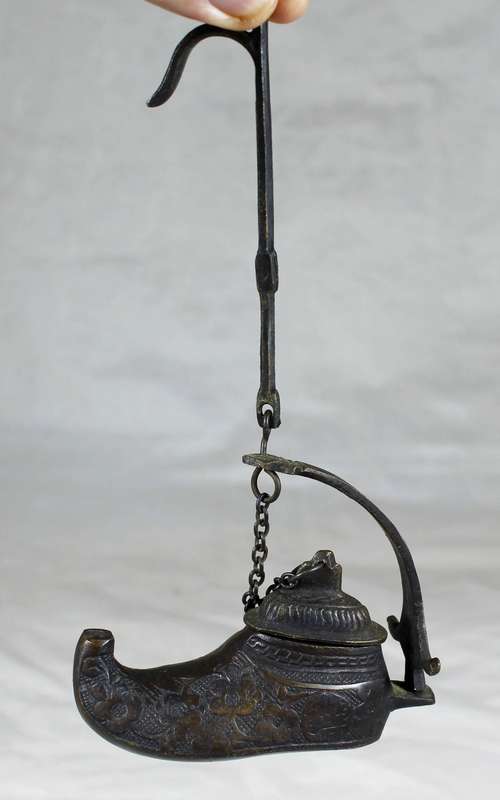 Vintage brass oil lamp in a boot shape