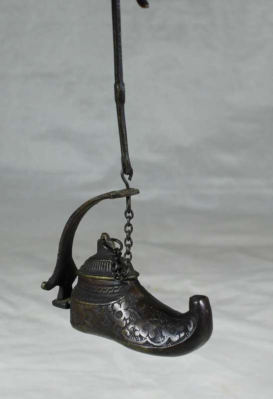 Vintage brass oil lamp in a boot shape