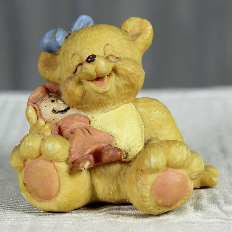 Little girl bear with doll in pink dress