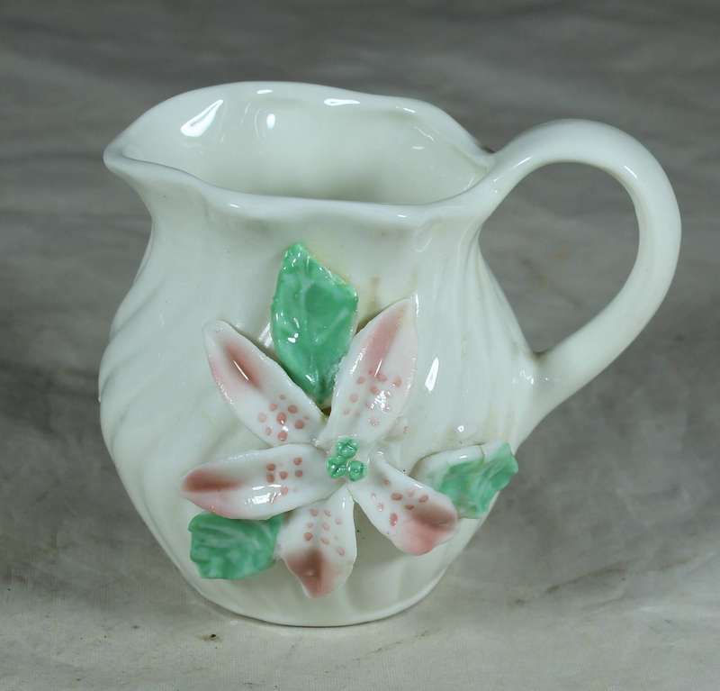 Small milk jug with embossed orchid flower