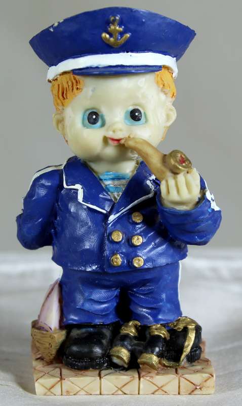 Boy sailor figure smoking a pipe