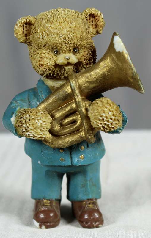 Little boy bear in blue suit with musical instrument